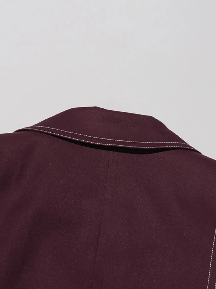 Blazer long à coutures contrastées pour femme revers cranté double boutonnage longueur maxi