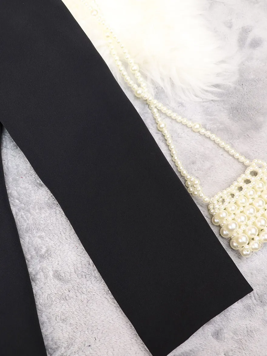 Blazer long à devant ouvert pour femme coupe ample et décontractée avec revers. Veste de tailleur noire décontractée.