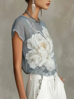 Blouse transparente à manches courtes et imprimé floral style aquarelle vintage en mousseline ample.