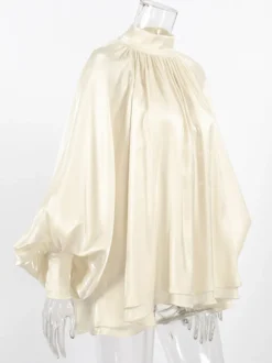 Chemisier oversize en satin crème brillant à col montant froncé manches ballon et poignets perlés