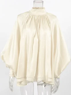 Chemisier oversize en satin crème brillant à col montant froncé manches ballon et poignets perlés