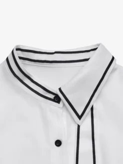 Chemisier péplum à col bordé noir col nœud papillon manches longues coupe ajustée