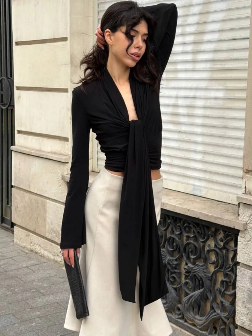 Haut court à nouer sur le devant et décolleté en V profond froncé blouse cintrée à manches longues et coupe évasée.