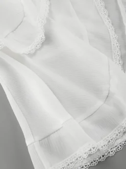 Jupe mini asymétrique à taille élastique et bordure en dentelle à volants