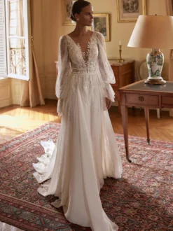 Robe de mariée bohème en mousseline et dentelle coupe trapèze avec traîne taille naturelle fermeture éclair manches longues col en V blanche
