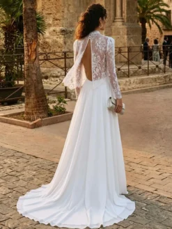Robe de mariée deux pièces en dentelle et mousseline col rond coupe trapèze avec traîne boutons et manches longues.