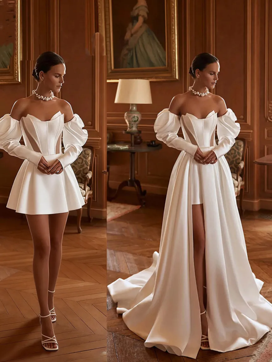 Robe de mariée deux pièces en satin décolleté travaillé coupe trapèze avec traîne fermeture éclair manches 3/4 longues
