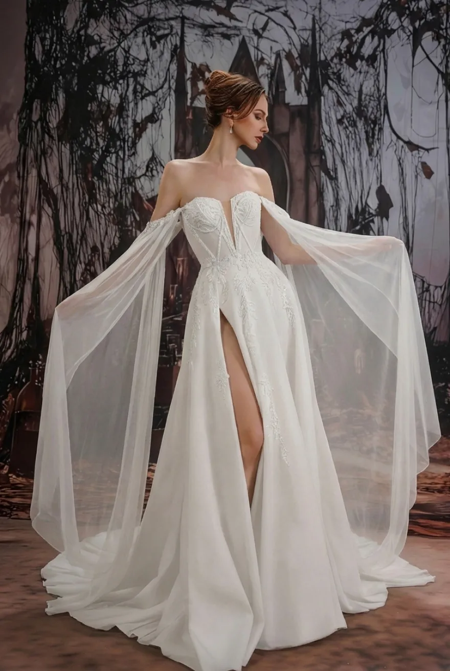 Robe de mariée gothique noire en dentelle coupe trapèze manches longues taille naturelle à volants et traîne