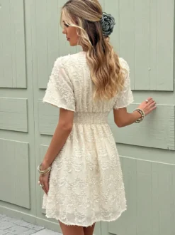 Robe d'été courte et ample couleur abricot clair texture plumes 3D col en V manches à volants taille élastique.