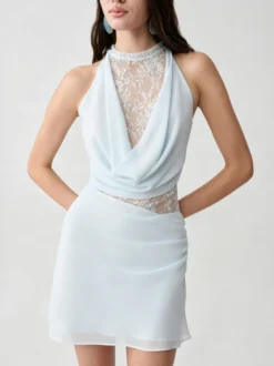Robe mini dos nu en dentelle et tulle ajouré drapée sur le devant idéale pour une soirée cocktail.