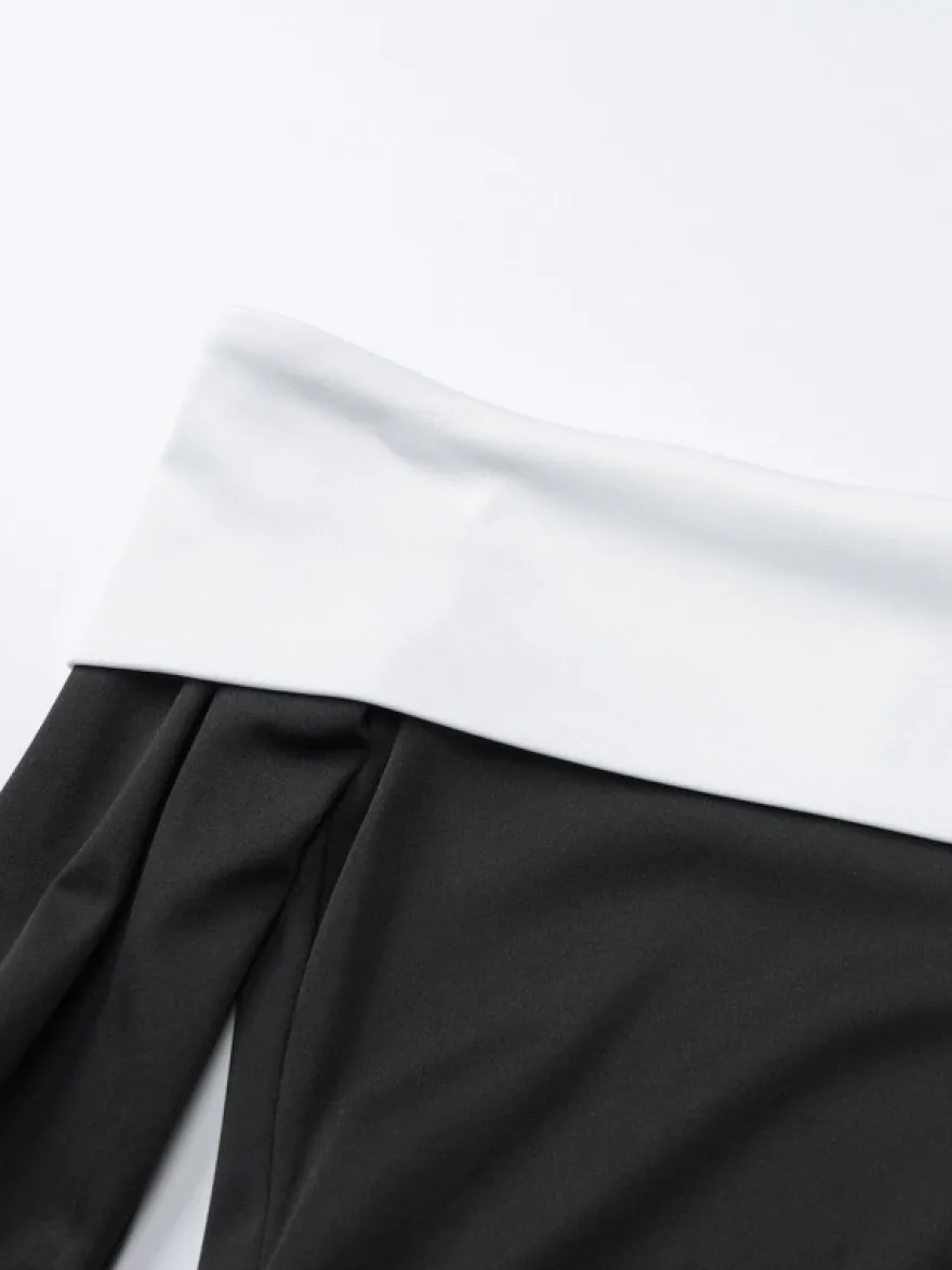 Robe noire chic à manches longues et mini bicolore épaules dénudées idéale pour un rendez-vous galant.