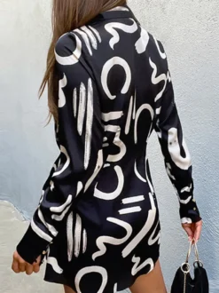 Robe noire élégante à manches longues et coupe asymétrique idéale pour tous les jours.