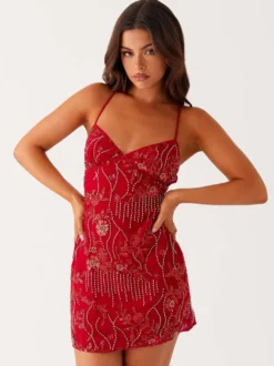 Robe orange cintrée et élégante ornée de sequins floraux parfaite pour les fêtes