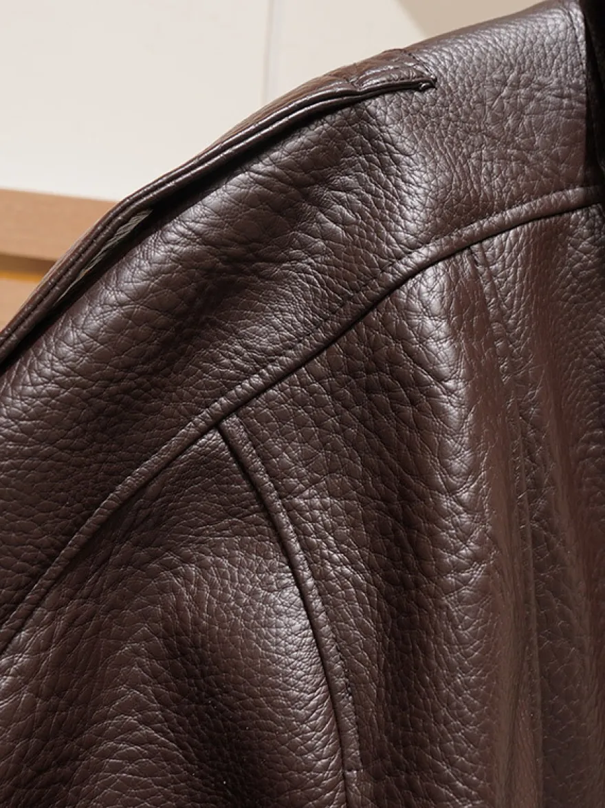 Veste bomber vintage en similicuir noir et marron uni coupe décontractée taille élastiquée.